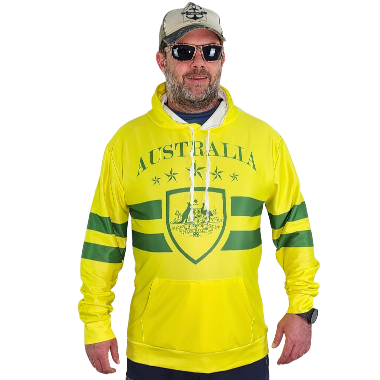 Man wearing a green and gold Australia themed hooded shirt. The man is also wearing a anchor hat and sunglasses. 