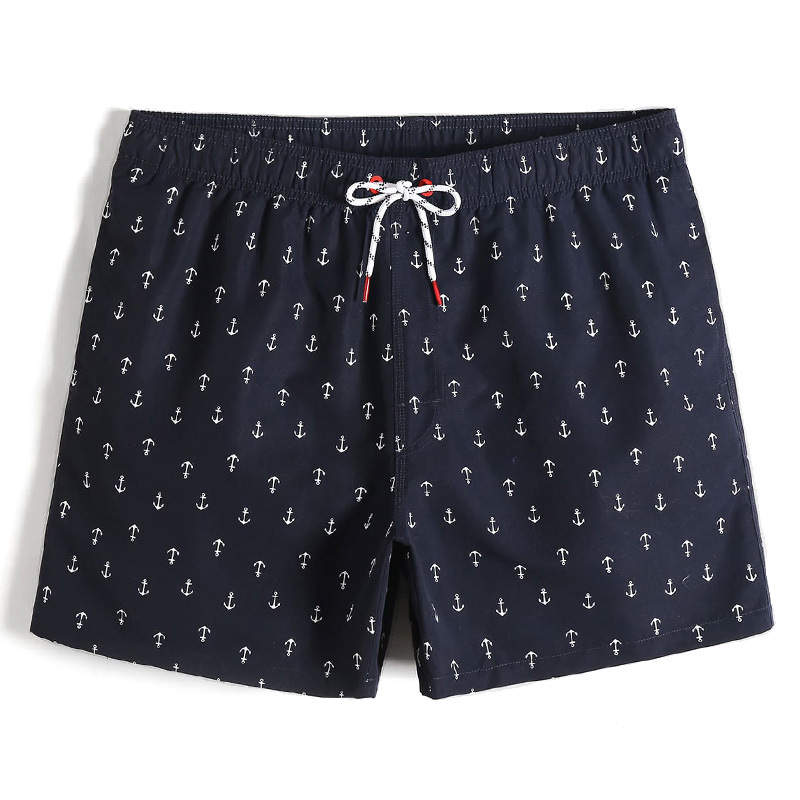 men's navy blue shorts with white anchor design. White drawstring with red eyelets. The cloth is quick drying.