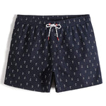 men's navy blue shorts with white anchor design. White drawstring with red eyelets. The cloth is quick drying.