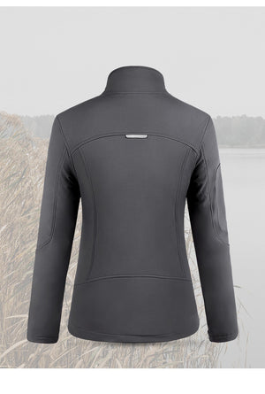 Back of women's grey hiking jacket with bushland and lake in the background.