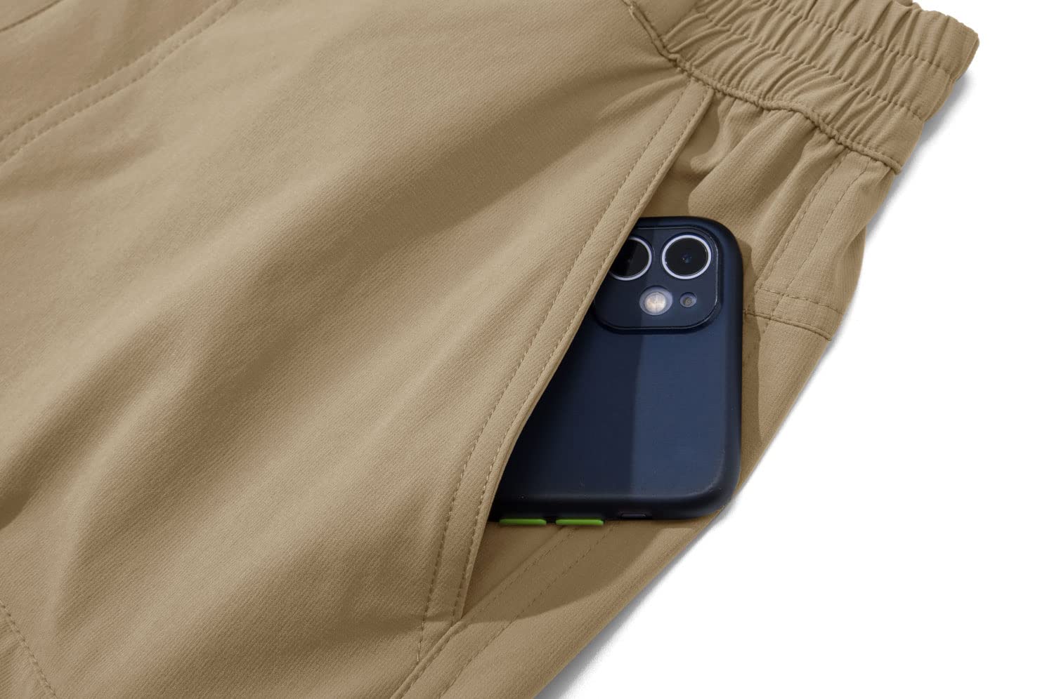 Mobile phone sticking out of side pocket of a pair of khaki work shorts. 
