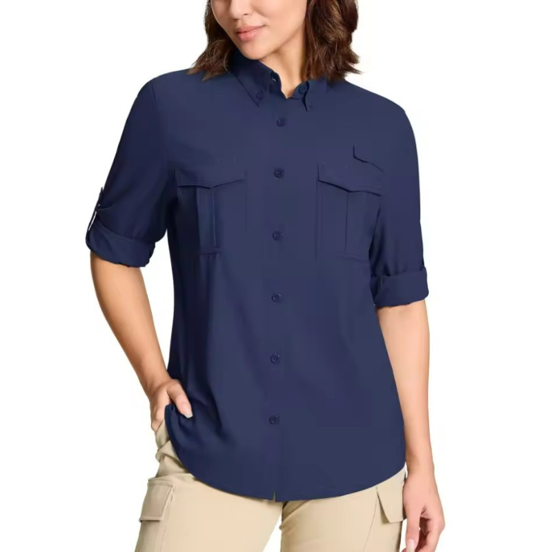 Woman wearing a navy blue shirt with rolled-up sleeves on a white background.