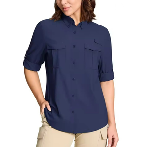 Woman wearing a navy blue shirt with rolled-up sleeves on a white background.