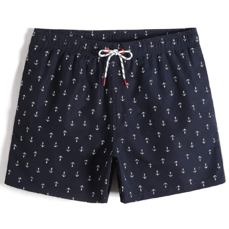 Men's navy swim shorts with little white anchors. White drawstring with red tips and red eyelets.