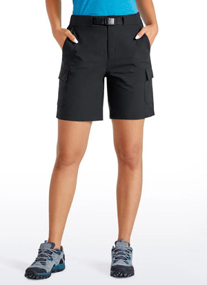 Model wearing the Women's Cargo Hiking Shorts in black. She is also wearing hiking shoes and a blue top.