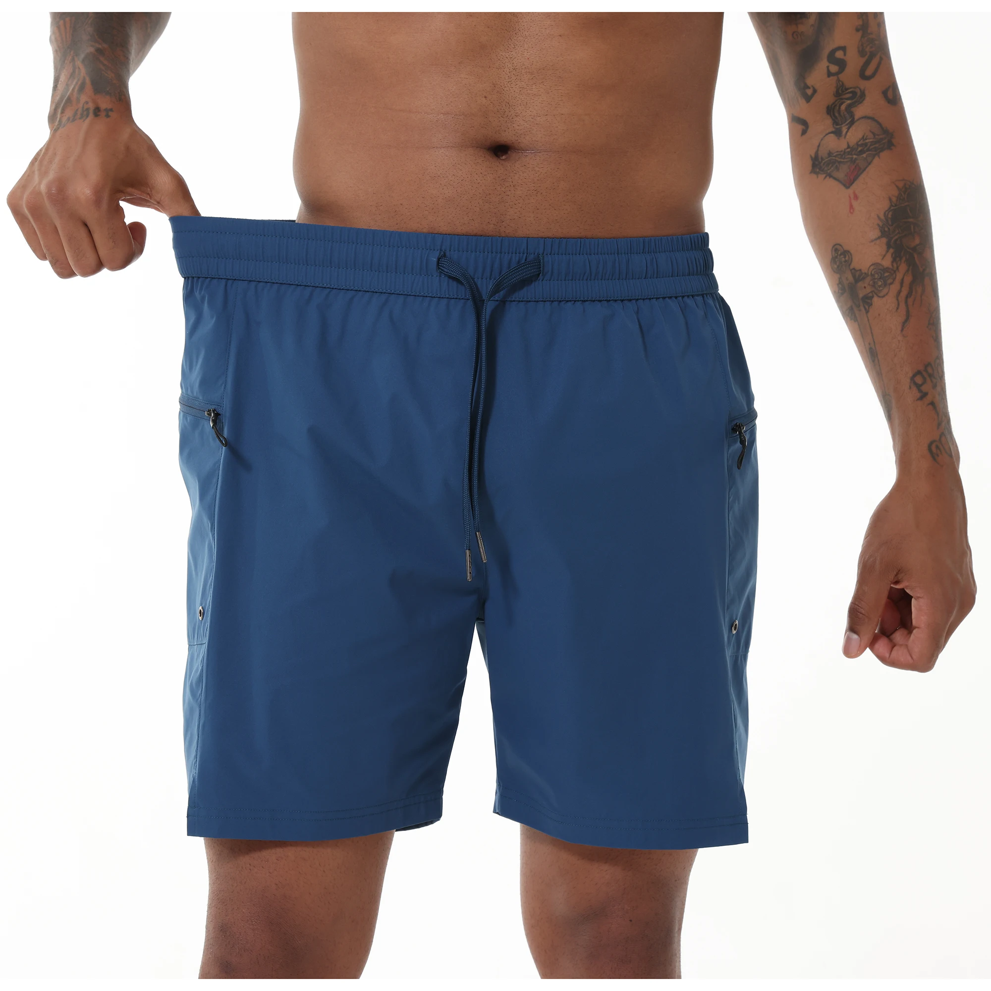 Man stretching out the elastic waistband of his blue swim shorts.