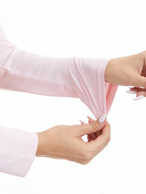 Person wearing a pink long sleeve top on a white background.