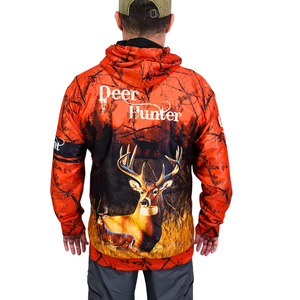 Man wearing a hoodie with a deer in woods design. 