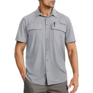 Male model wearing a light grey short sleeve shirt that has many pockets.