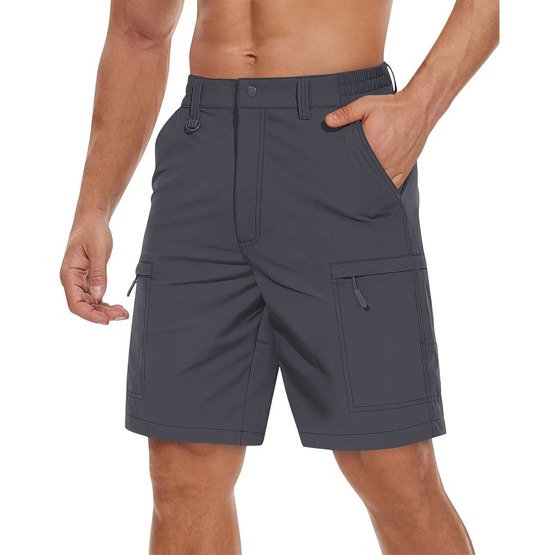man wearing a pair of dark grey hiking shorts with hand in pocket. The shorts have zip pockets and are water resistant. 