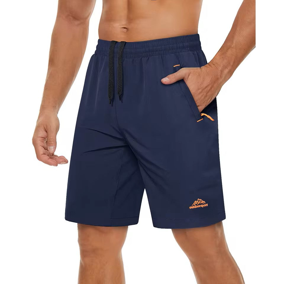 Male model with no shirt on wearing Navy blue shorts with orange accents on a white background.