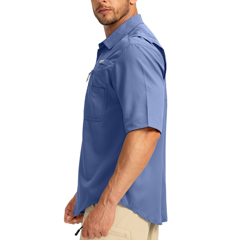 Side on view of a man wearing a blue short sleeve button up fishing shirt designed by Gradual. 