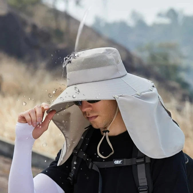 Water being poured onto a water-resistant fishing hat.