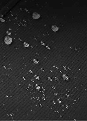 Water droplets on top of waterproof cloth used to make women's hiking pants.