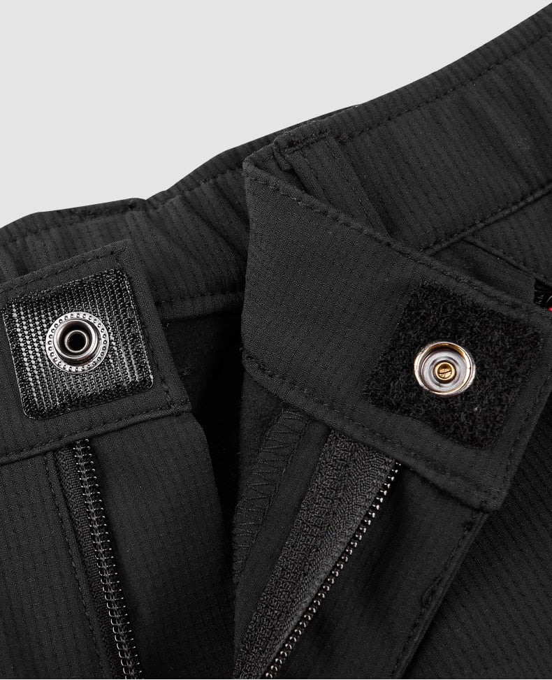 Zip, button and Velcro fly on women's outdoor pants.