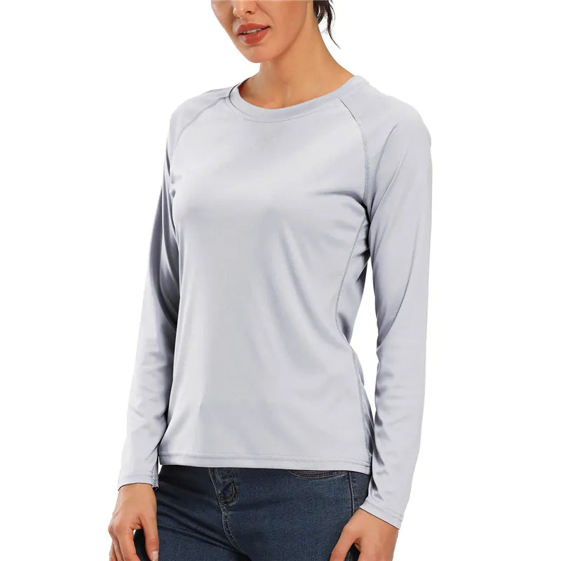 Female model wearing the Women's Light Grey UPF 50+ Long Sleeve T-Shirt and dark blue denim jeans.