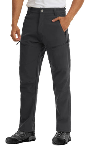 Male model wearing warm waterproof pants that can be purchased at Guts Fishing Apparel. The pants have 5 zip pockets and a fleece lining. 