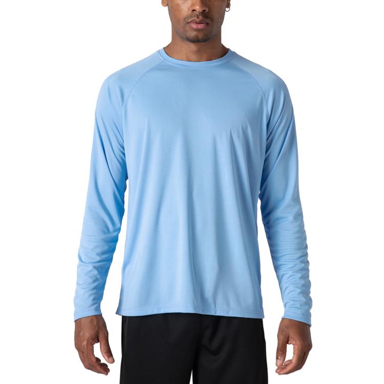 Male model wearing a blue, long sleeve t-shirt for sun protection.