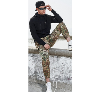 Male model wearing men's relaxed fit military style cargo pants. 