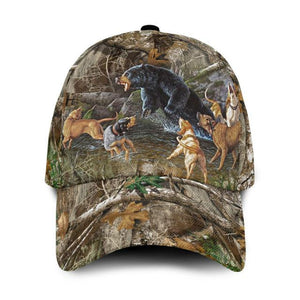 A cap with dogs hunting a black bear in the forest.