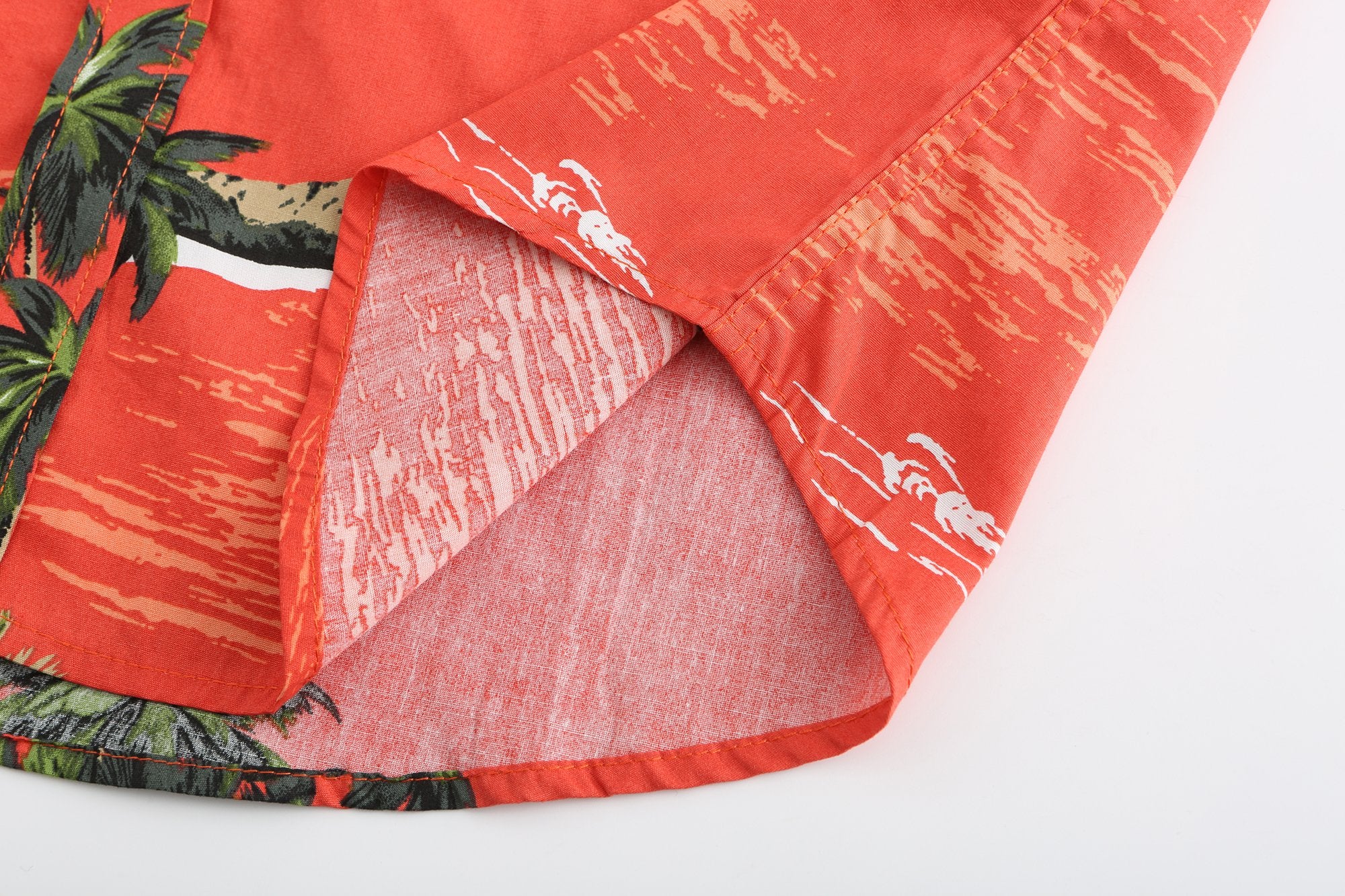 The hem of a red Hawaiian shirt mad from lightweight cloth.