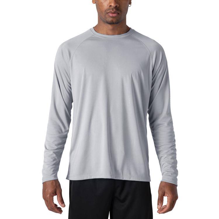 Male model wearing a grey, long sleeve t-shirt for sun protection.