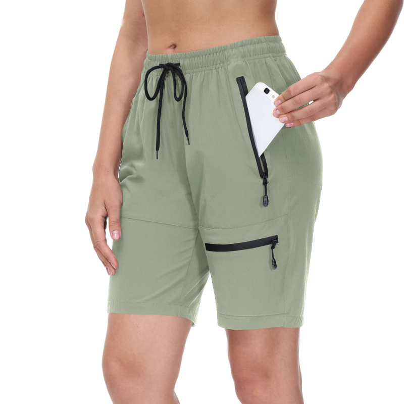 Women's lightweight cargo shorts with elastic waist, drawstring and zip pockets. Quick drying and stretch fabric. Mint green polyester and spandex.