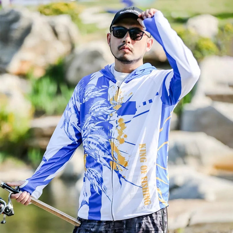 Male model wearing the King of Fishing sun protection shirt. The man is holding a fishing rod  and is also wearing a black hat and sunglasses.