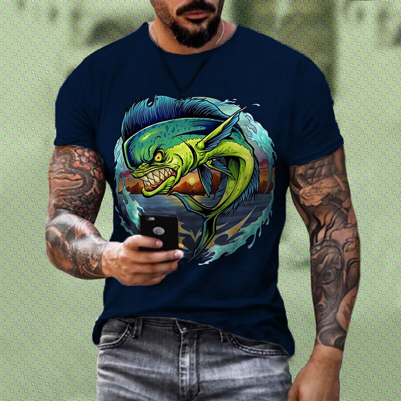 Man wearing a t-shirt with an angry looking Mahi Mahi Dolphin fish printed on it. The fish is jumping out of the water with the sun setting behind the mountains. 