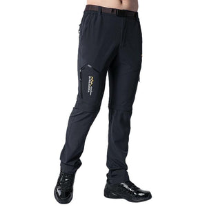 Quick dry hiking pants with zip off legs in the colour black. The brand name is mountain skin