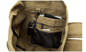 Inside view of the Khaki Canvas Rucksack with three internal pockets and d-ring.