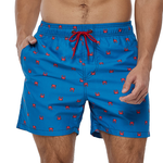 Man wearing a pair of quick drying shorts. Blue with red crab printed on them.