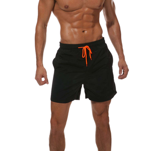 Mussily man wearing a pair of black quick drying shorts for swimming and exercise.
