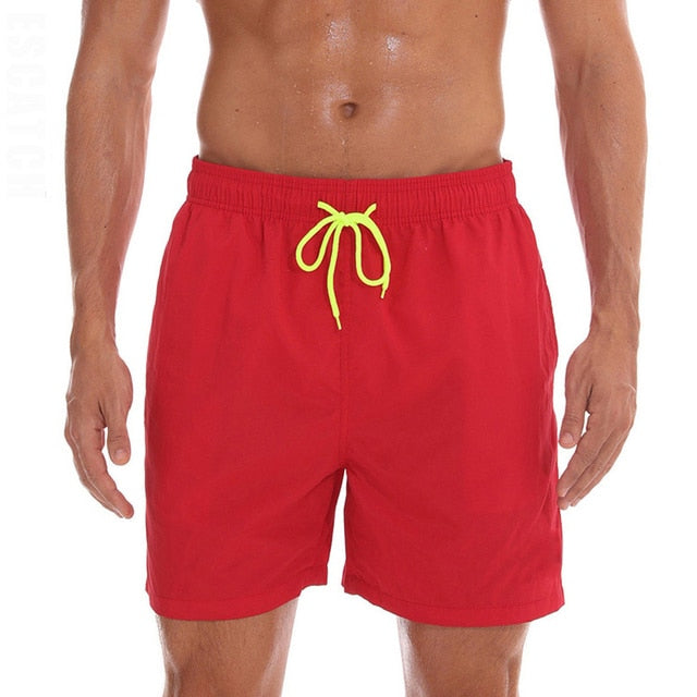 Men's swim shorts red with yellow drawstring.