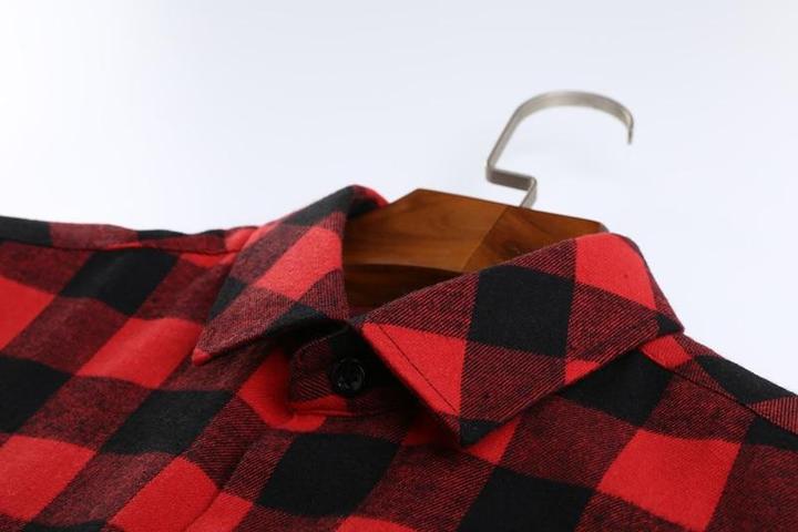 Red check shirt on clothes hanger laid flat show the flannelette fabric. 