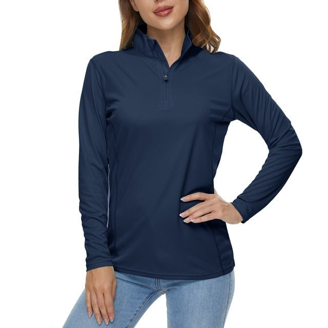 A girl wearing a navy blue long sleeve top. The shirt has a zip-up collar and is used to protect your skin from the sun.