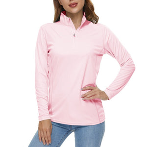 Light pink long sleeve shirt is being worn by a female model with her hands on her hips. The shirt has a collar and long sleeves.