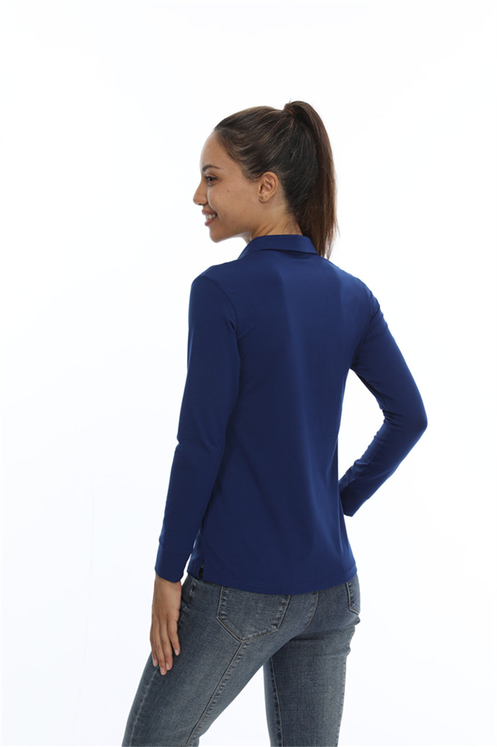Female wearing a navy long sleeve UPF 50+ sun protection sports polo shirt.