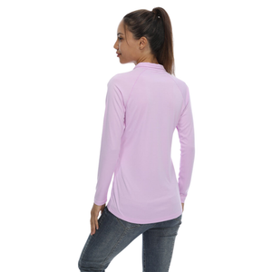 Female model with her back turned wearing a light purple sun protection shirt with zip up collar and long sleeve. The cloth has a UPF 50+ sun protection rating. 