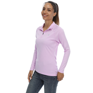 Female model with a nice smile wearing a light purple sun protection shirt with zip up collar and long sleeve. The cloth has a UPF 50+ sun protection rating. 