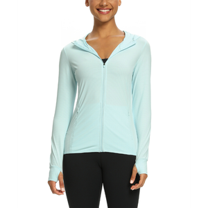 Female model wearing a light green zip-up sun protection shirt with a UPF 50 + rating. The shirt has long sleeve and a hood.