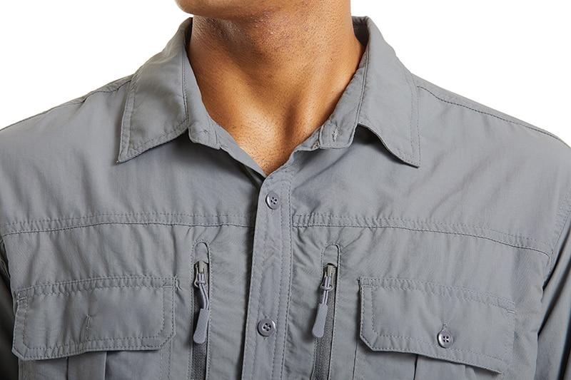 Male model wearing a grey shirt with multiple pockets on the front. 