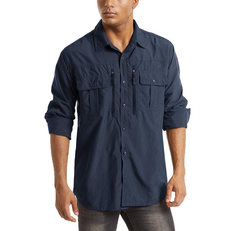 Male model wearing a navy long sleeve button-up outdoor shirt with zip pocks on the chest.