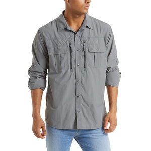 Male model wearing a vented nylon fishing shirt. The shirt is button up and it has zip pockets on the chest.